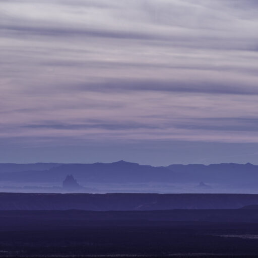Layers of desert mesas fading into blue evening haze